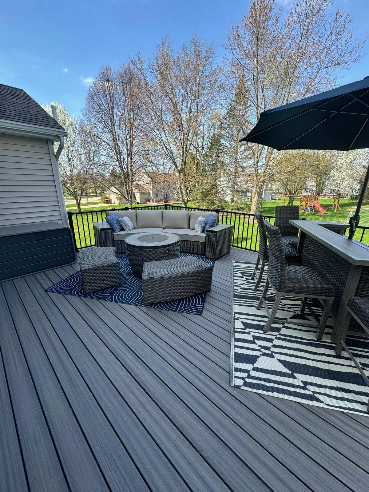 Composite deck with built-in fire pit and outdoor seating area